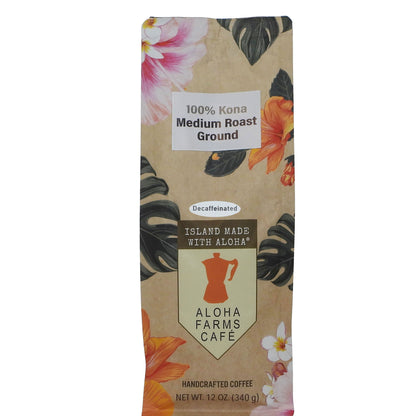A 12 oz bag of Aloha Farms Cafe 100% Kona Medium Roast Ground coffee, featuring a tropical floral and leaf pattern on a kraft paper background.